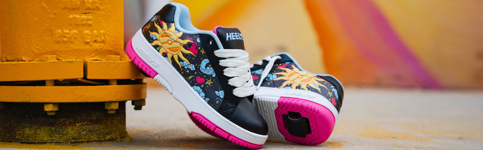 Colorful Girls Heelys roller shoes with floral patterns.