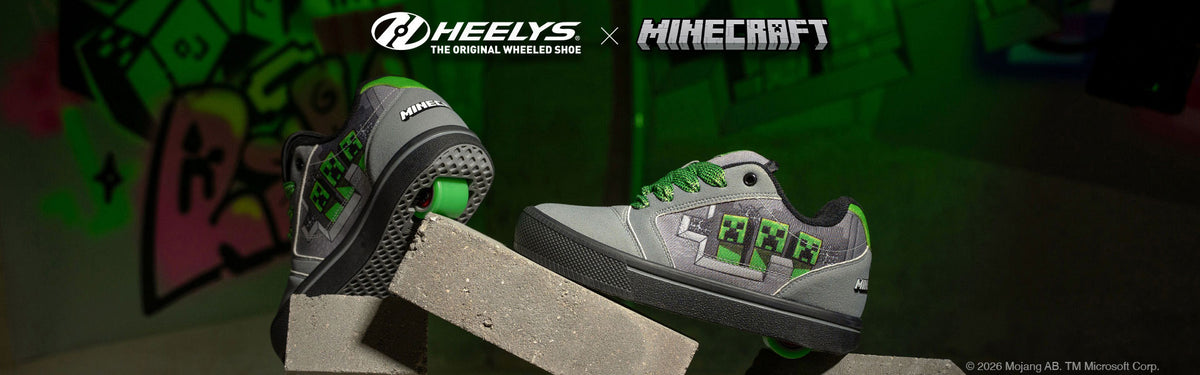 Heelys x Minecraft shoes in grey with green creeper artwork, displayed on concrete blocks.